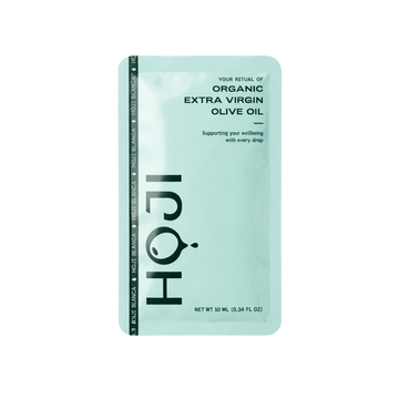The HOJI BLANCA 30 PACK by Hoji features single-serve Hojiblanca extra virgin olive oil sachets in a light green packet, promoting wellbeing, with each sachet containing 10 ml (0.34 fl oz).