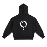 The HOJI HOODIE by Hoji is a heavyweight black hoodie shown from the back, featuring a large white drip logo shaped like a round droplet with a single drop falling at the center.