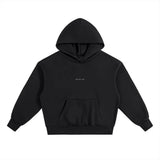 The HOJI HOODIE by Hoji is a heavyweight black hoodie with a front pocket, subtle OLIVE OIL text in white on the chest, and a clean drip logo design, shown on a plain white background.